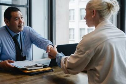 Student practicing for an interview with a man and shaking his hand